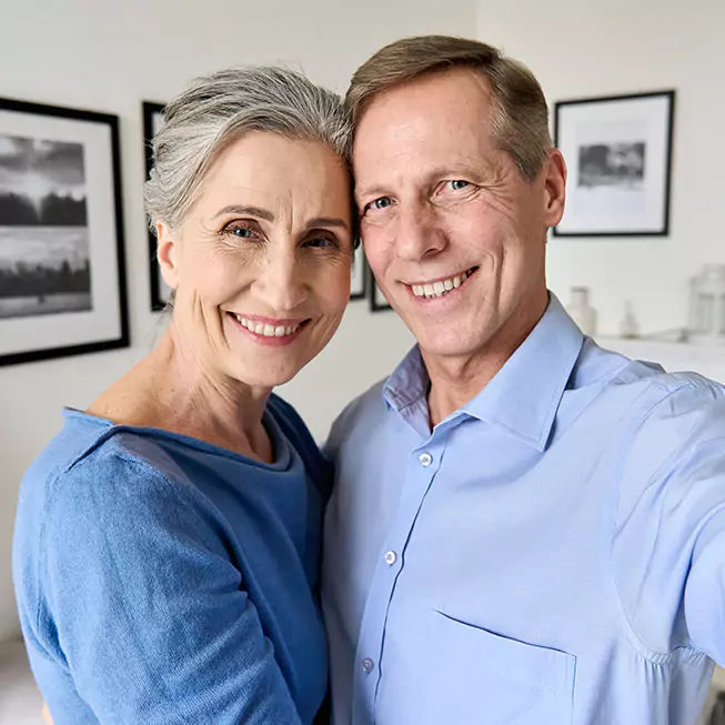 Couple smiling after All-on-4 Dental Implants